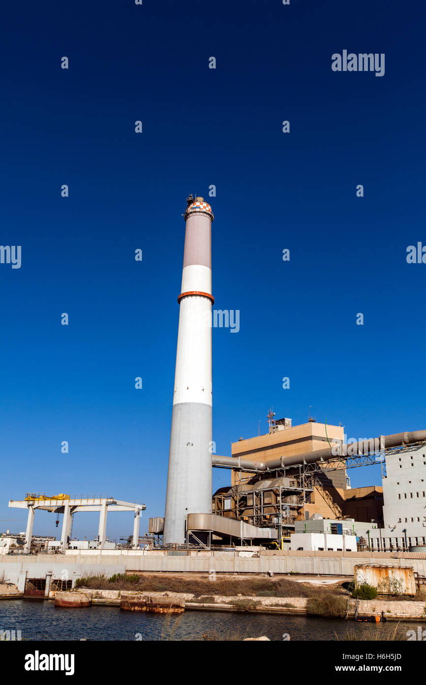 Fossil fuel power plant on a sunny day against clear sky Stock Photo