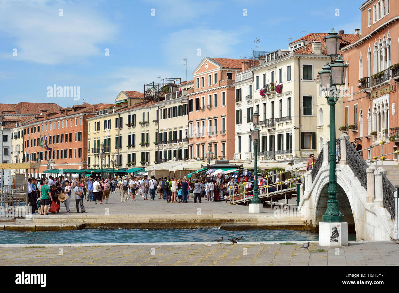 Waterfront Riva degli Schiavoni with Tourists in San Marco of Venice in Italy. Stock Photo
