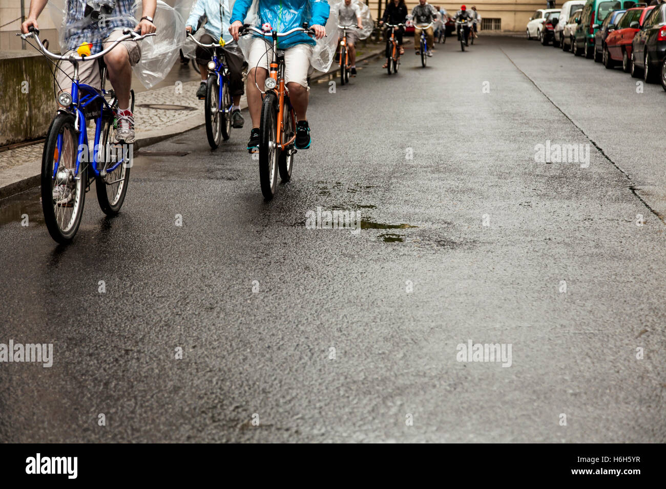 Group of cyclers on a wet street in a rainy day. Stock Photo