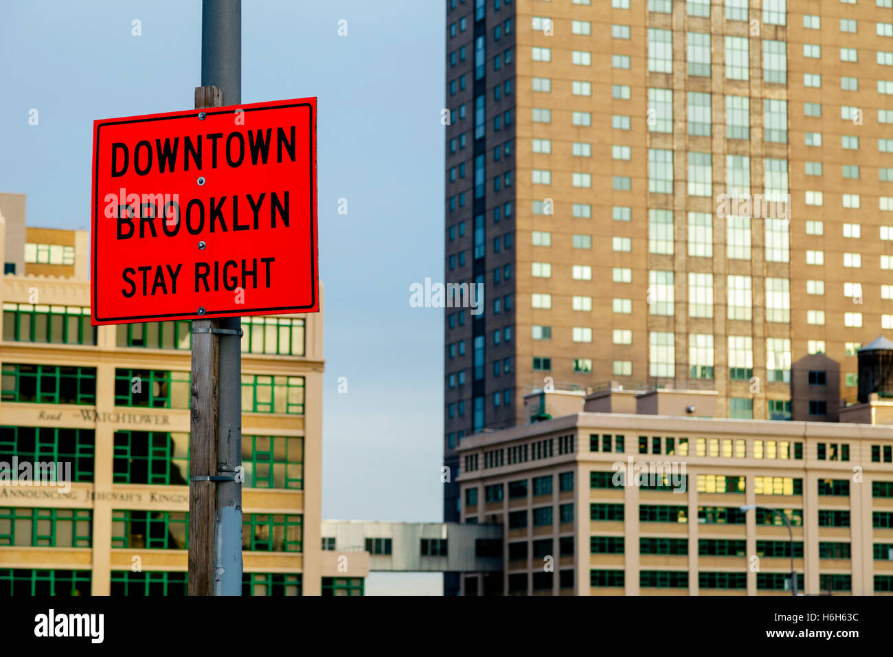 A sign on a post saying 'downtown Brooklyn stay right'. Stock Photo