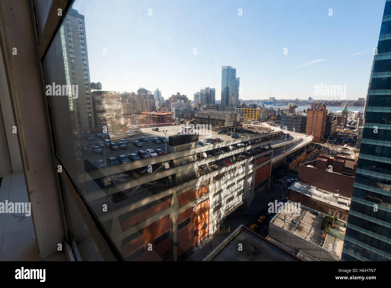 The NYC Port Authority's rooftop parking lot as seen through an adjacent building's window Stock