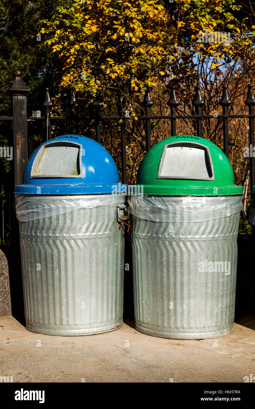 Two garbage bins in a park, one for paper and one for cans Stock Photo