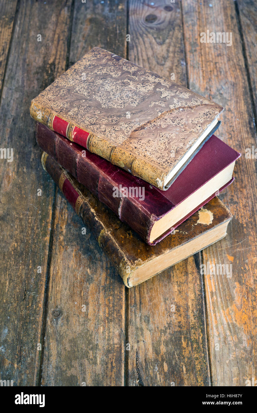 Three old books on wood background Stock Photo