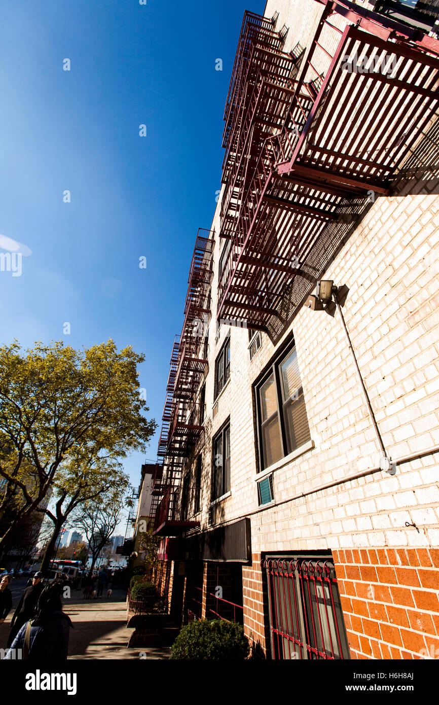 Low and wide angle view of a residential apartment building with the fire escape on the wall. Stock Photo