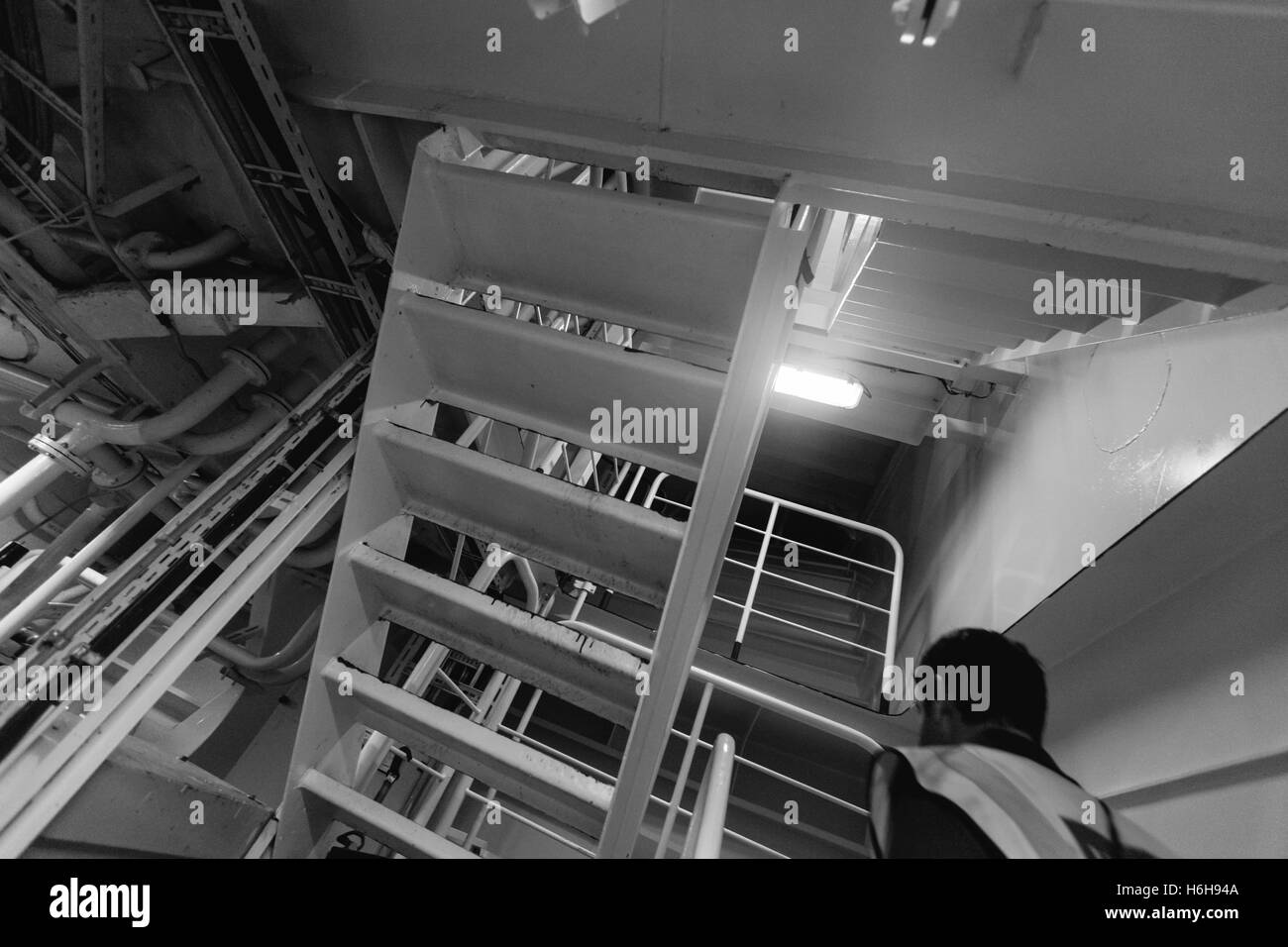 Anonymous person walking inside of a cargo ship Stock Photo