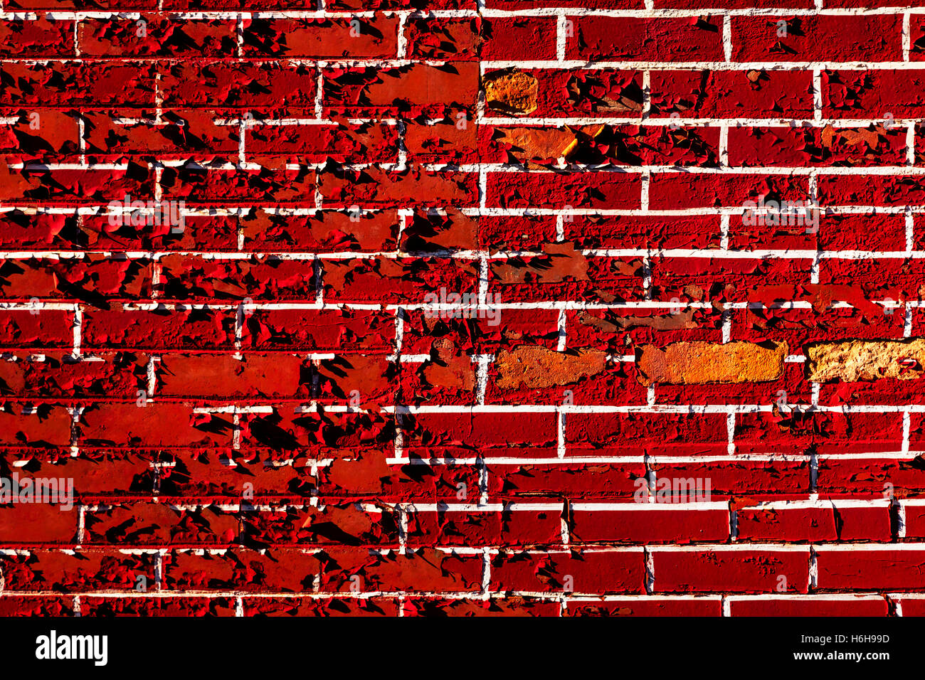 The pattern of white grout and red bricks painted on a brick wall is peeling off Stock Photo Alamy