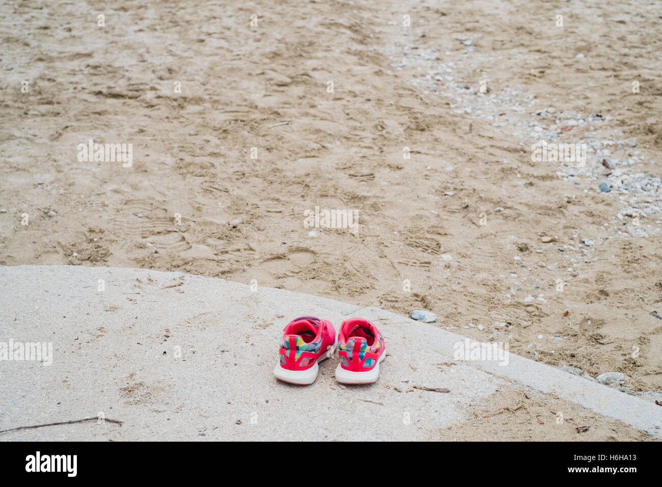 Pair of childs shoes left by Gyllyngvase Beach, Falmouth, Cornwall 25/10/2016 Stock Photo