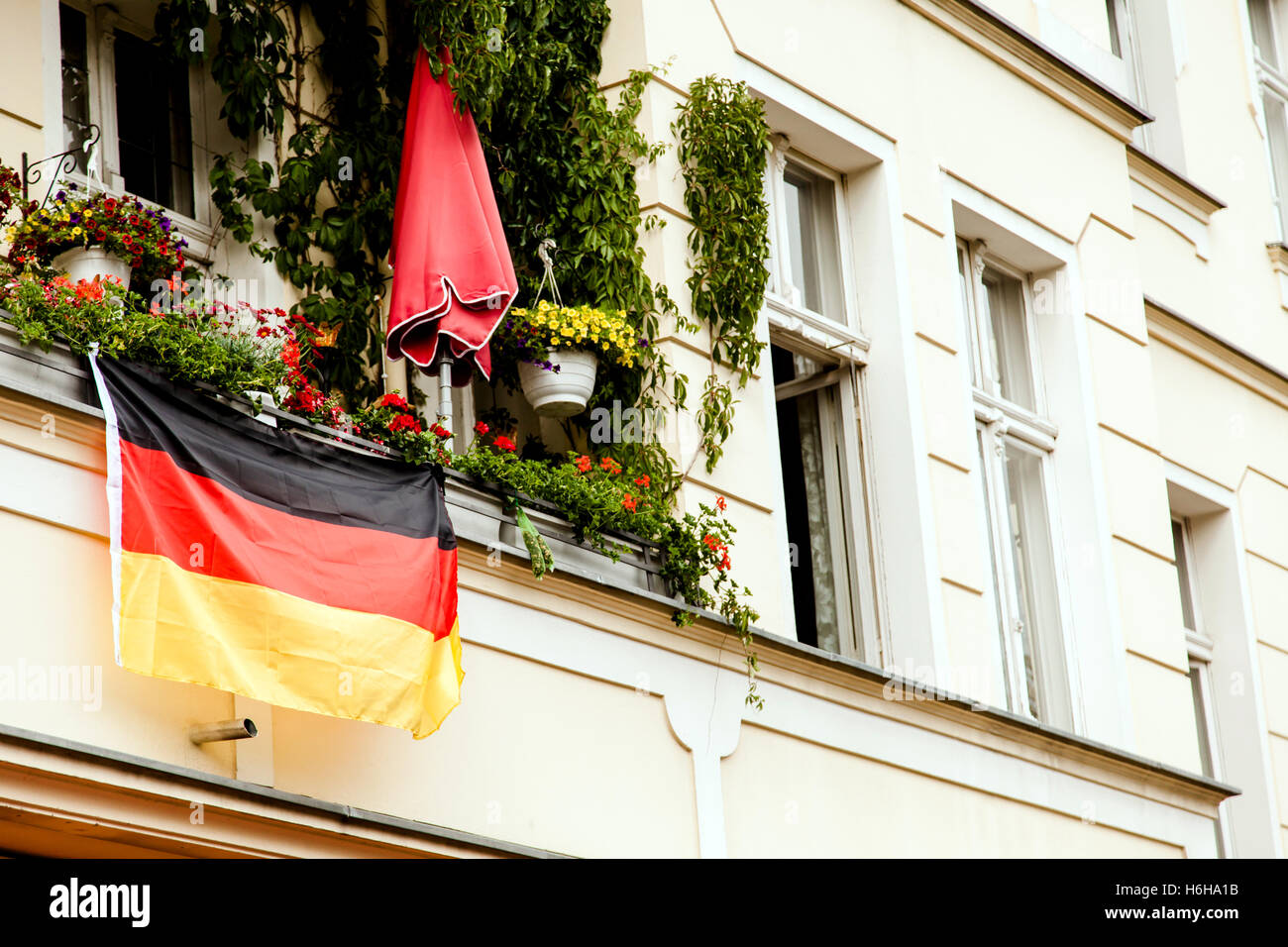 The German flag hanging off a porch of an apartment in Berlin Stock Photo Alamy