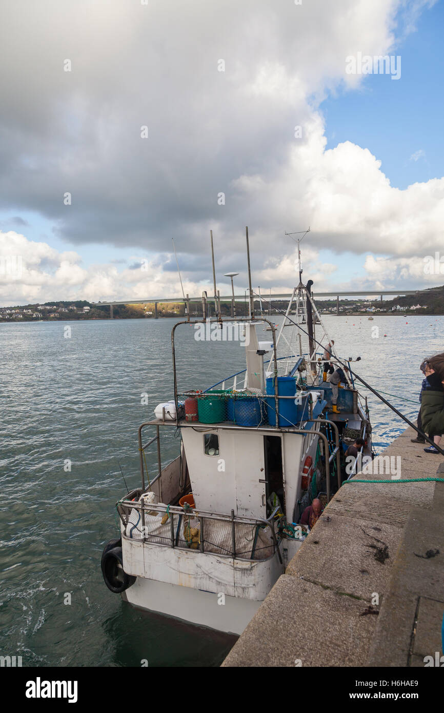 Fishing boat crew landing catch at Hobbs Point, Pembroke Dock, Wales
