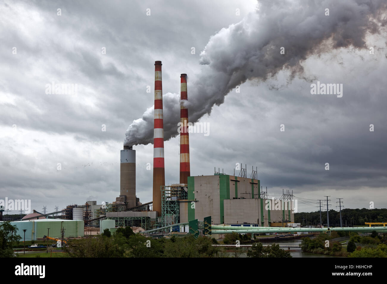 Coal and oil power generating plant with emitting clouds of polluted steam and smoke Stock Photo