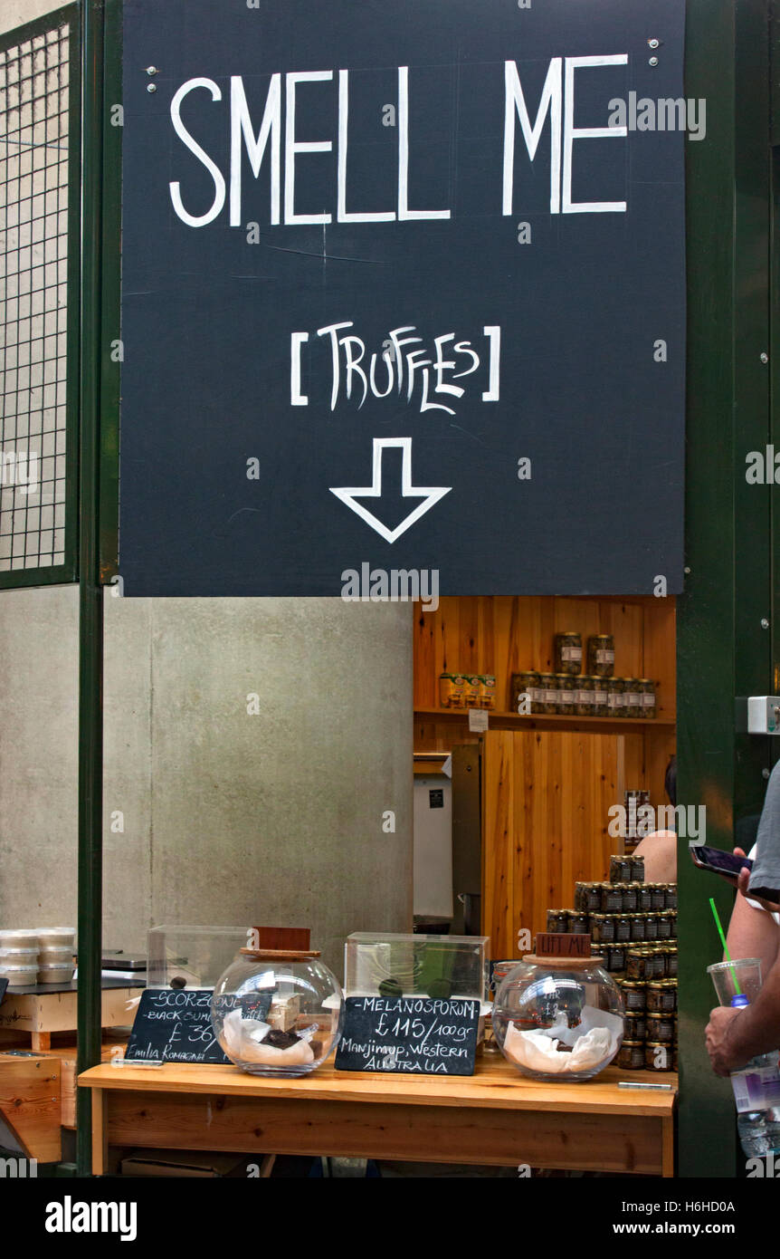 Sign encouraging shoppers to smell the truffles on a stall in Borough Market in Southwark near London Bridge Stock Photo
