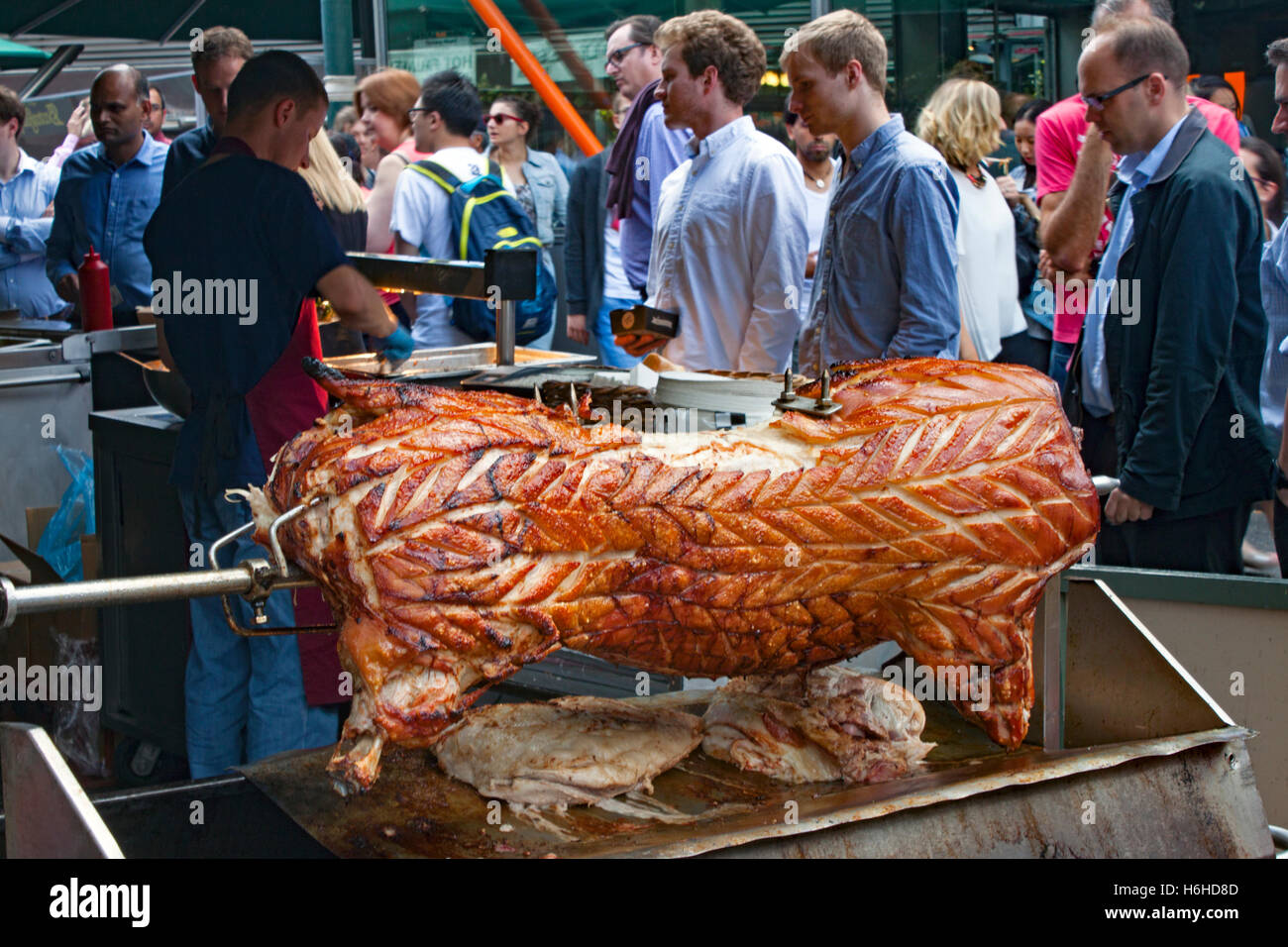 Roast pork stall, Borough Market in Southwark near London Bridge, with a whole pig on a spit. Stock Photo