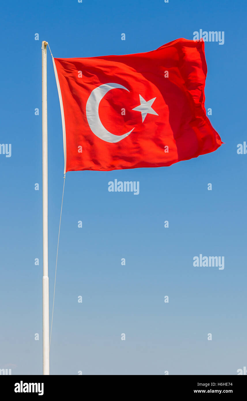 Waving flag of Turkey over blue sky background Stock Photo
