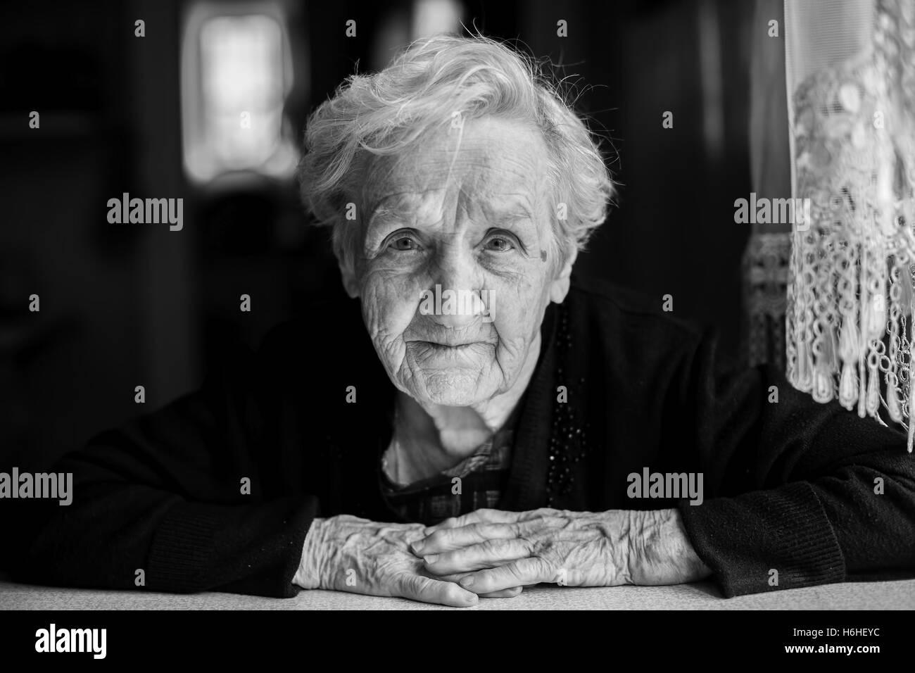 Black and white contrast portrait of an elderly woman. Stock Photo