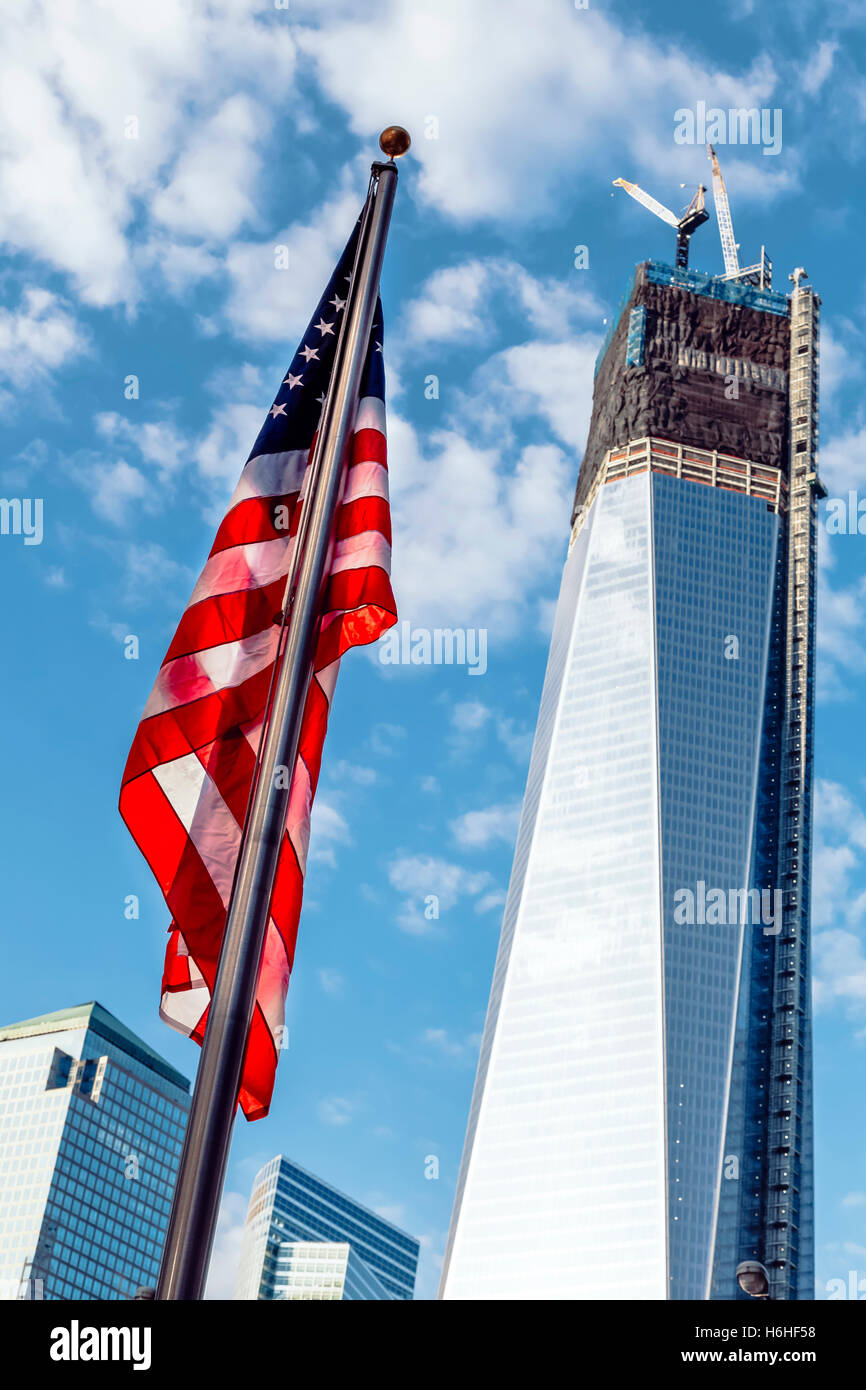 NEW-YORK - NOV 9: 1 World Trade Center building is under construction, with the American flag fluttering in the foreground on No Stock Photo