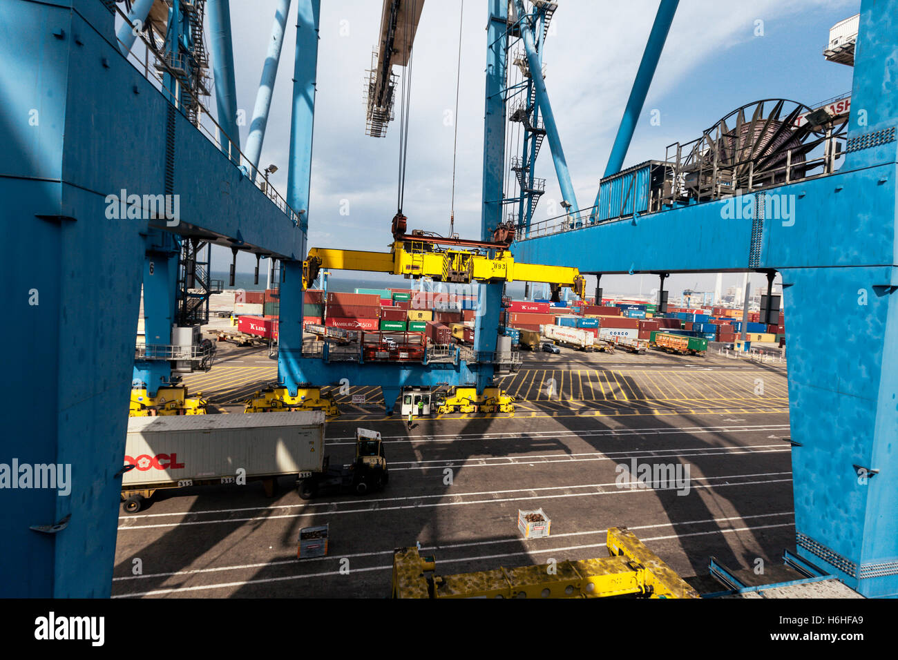 ASHDOD, ISRAEL - OCTOOBER 12: Container truck arriving to its spot under a massive harbor crane, for the purpose of unloading th Stock Photo