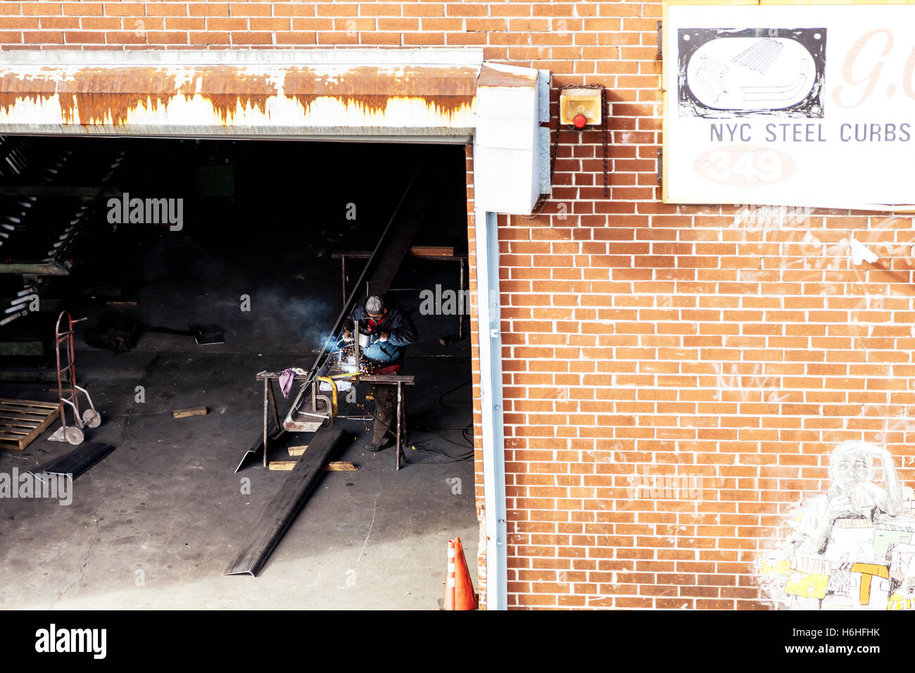 NEW-YORK - NOV 14: Worker welding steel in a steelsmith's shop in New-York, USA on November 14, 2012. Stock Photo