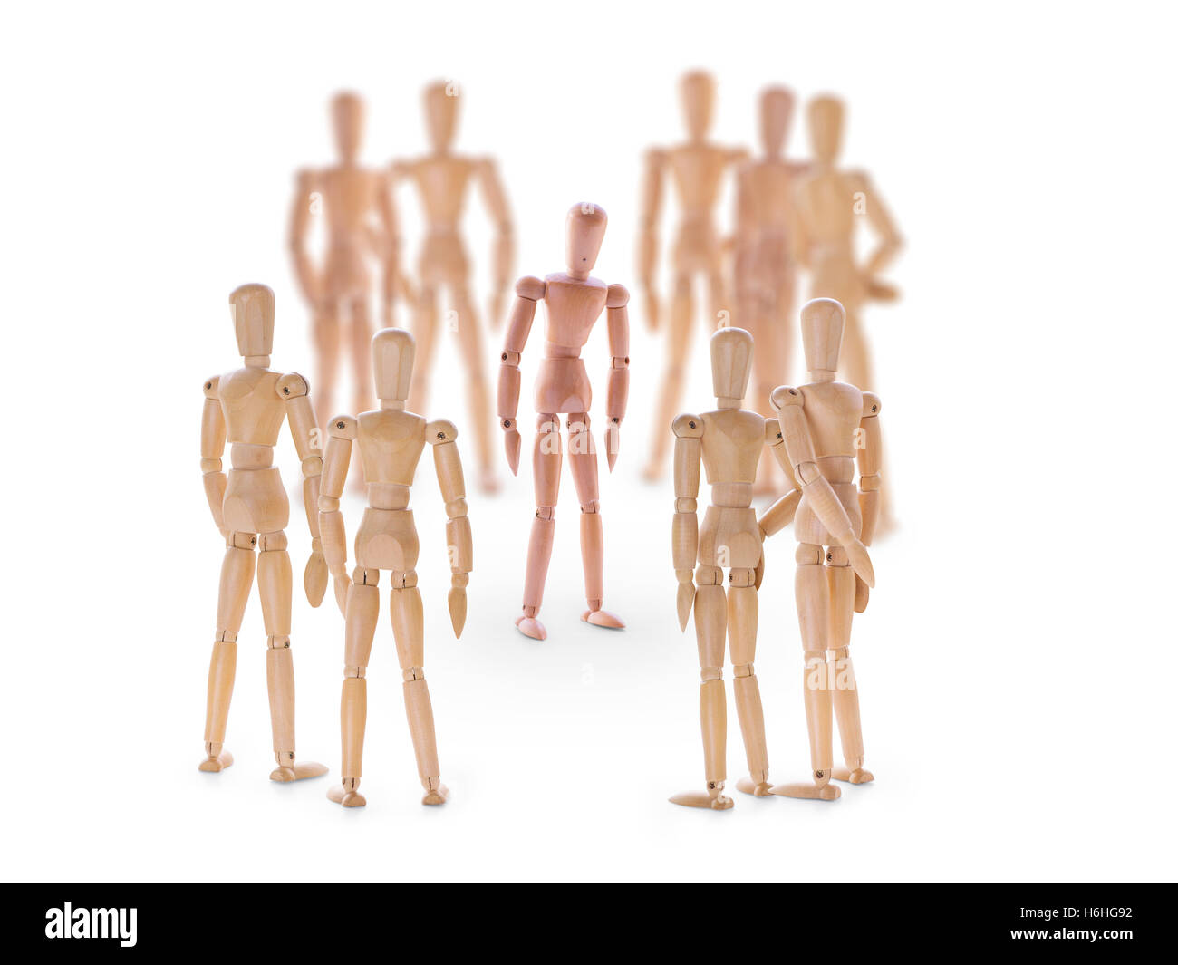 Dummy characters. Different one in center of the crowd. On white background. Standing out from the crowd, outcast in a team or c Stock Photo