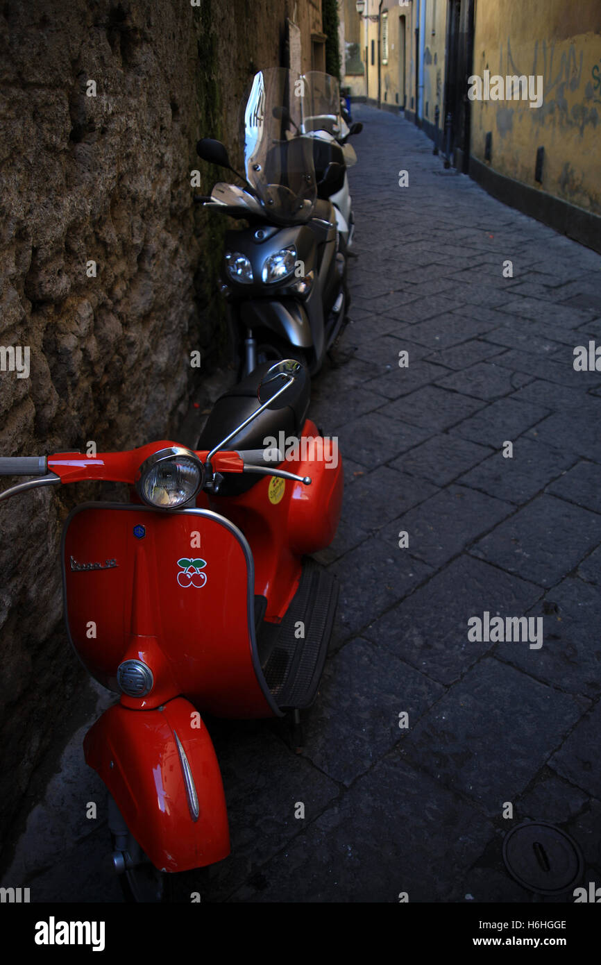 A red motorcycle parked in a quiet street in Sorrento Southern Italy Stock Photo