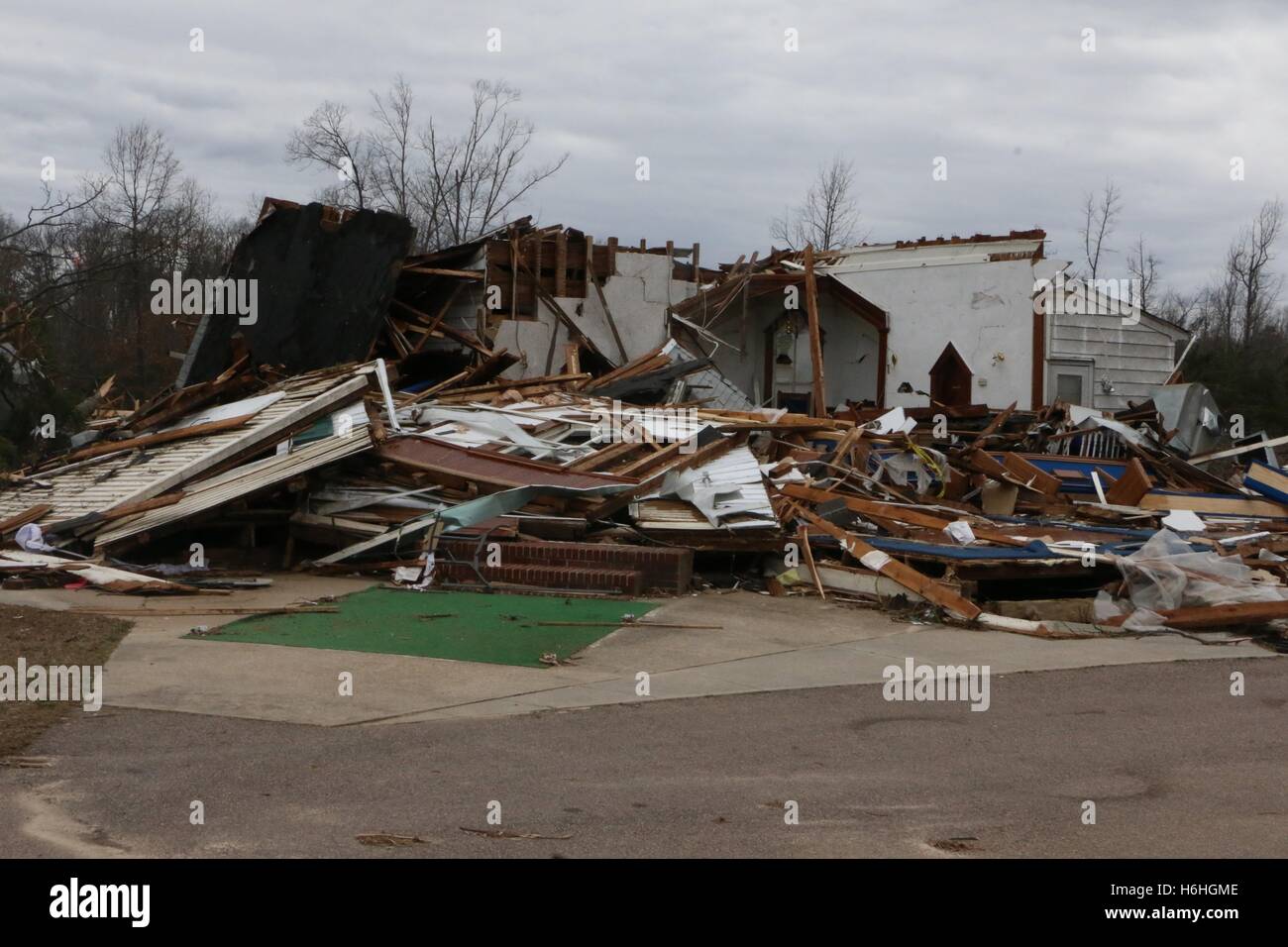 Debris from a destroyed house blocks a road after a severe storm and tornado February 25, 2016 in Essex County, Virginia. Stock Photo