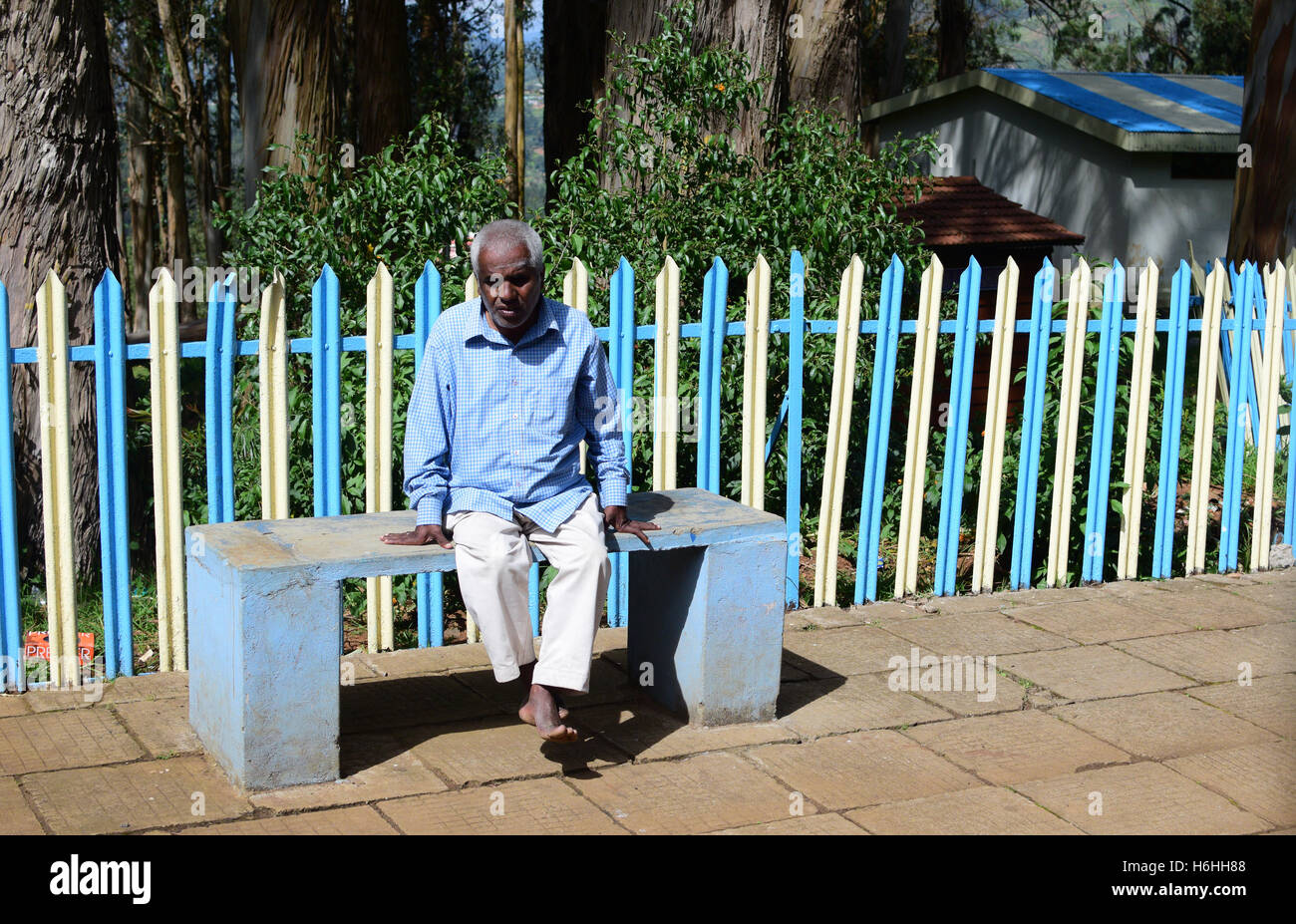 Old age Senior Man waiting lonely in Railway Station Tamil Nadu India Stock Photo