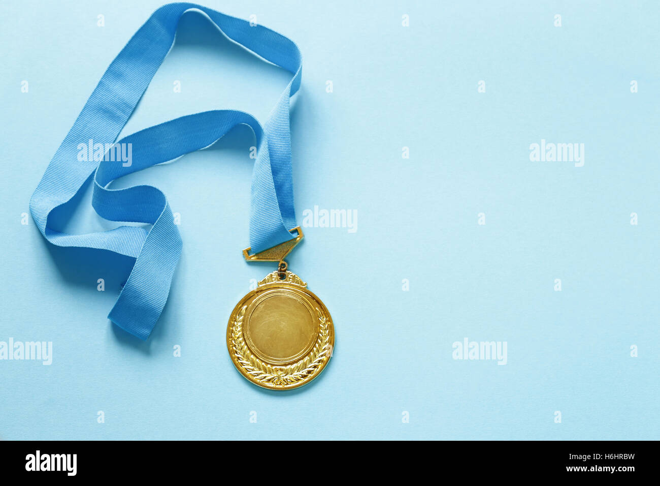 Gold medal with ribbon. The victory and the first place. Stock Photo