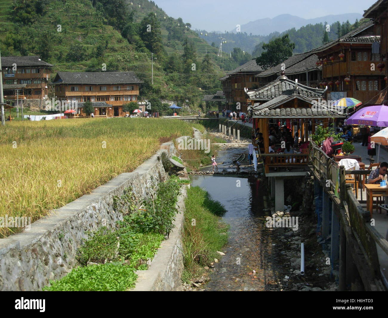Wooden houses and small river inside Dazhai traditional village, Guilin, Guangxi province, China Stock Photo