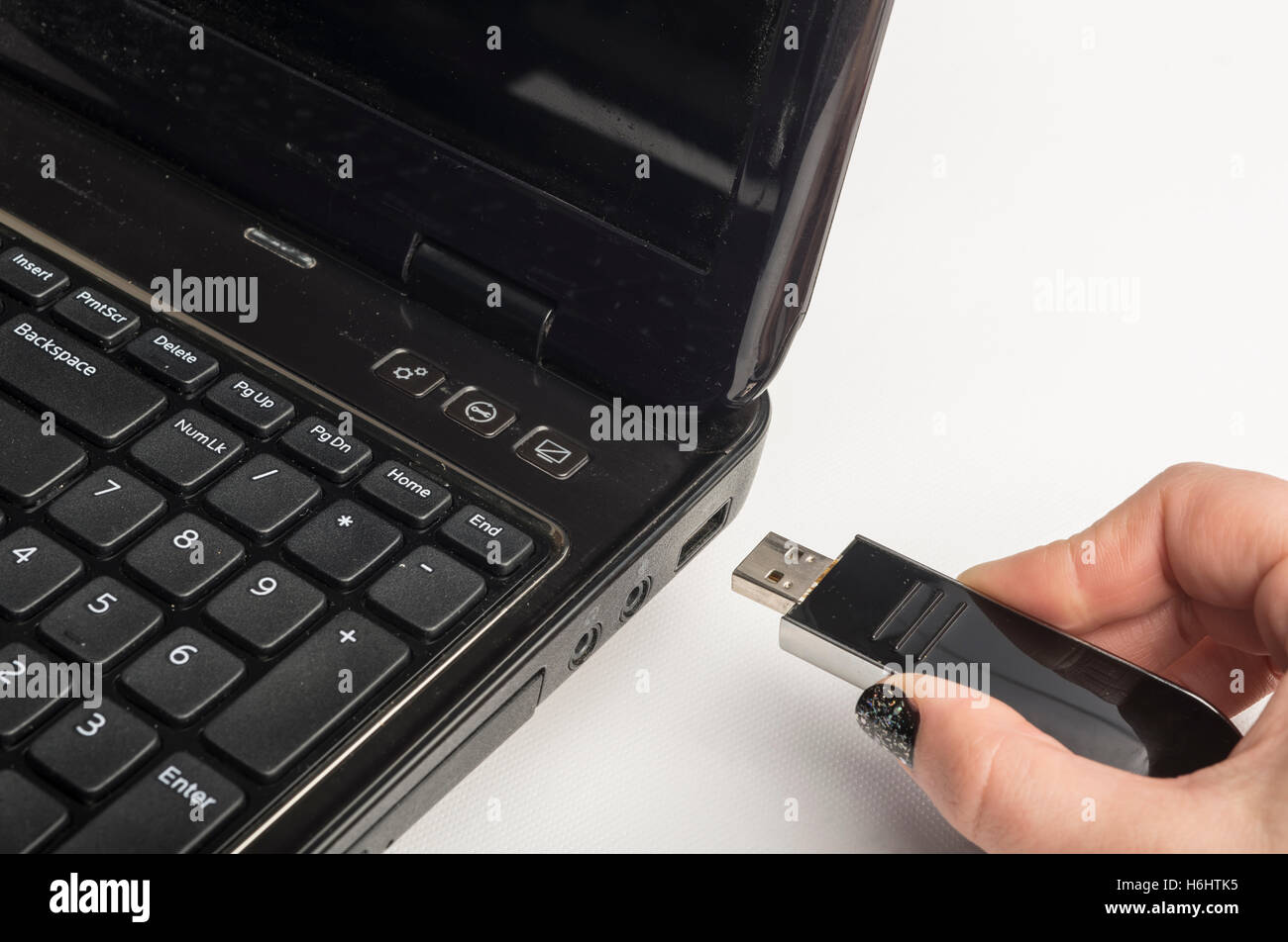 Hand inserting usb memory stick to laptop computer Stock Photo Alamy
