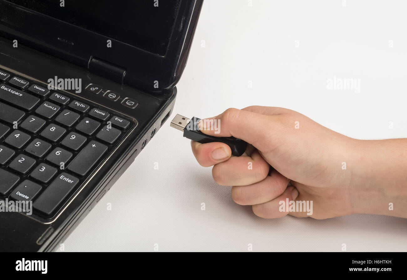 Hand inserting usb memory stick to laptop computer Stock Photo Alamy