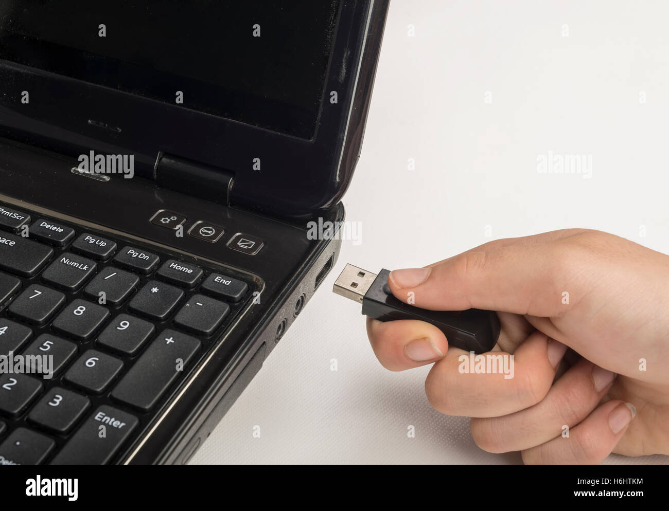 Hand inserting usb memory stick to laptop computer Stock Photo Alamy