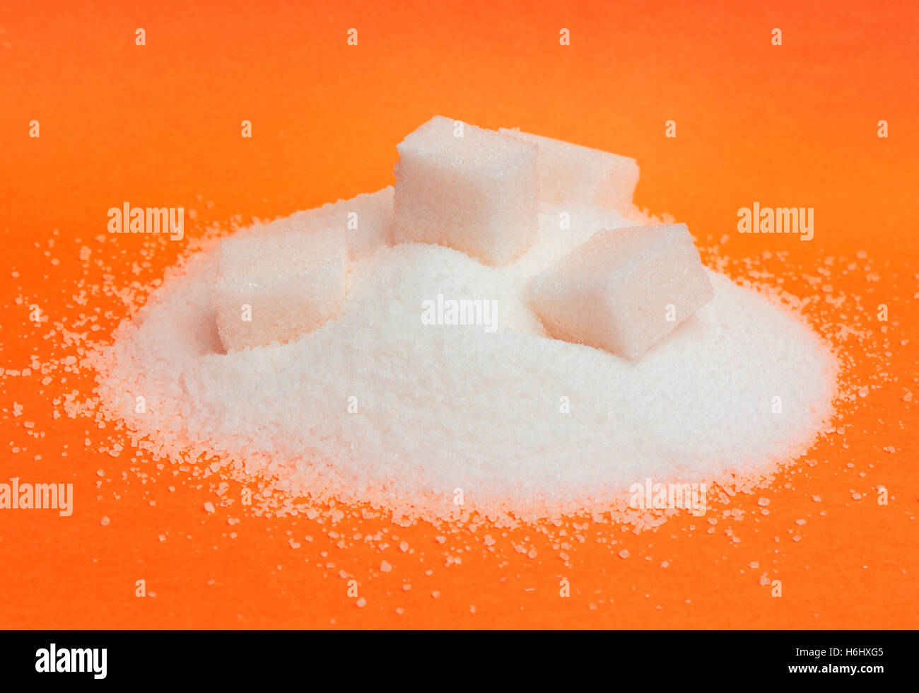 Pile of white sugar isolated on red background Stock Photo
