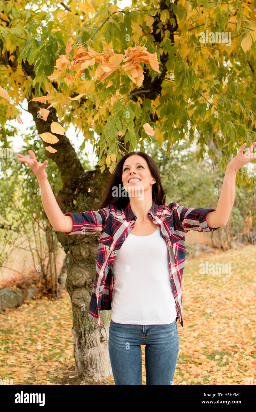 Beautiful brunette girl taking a walk by a park in autumn Stock Photo ...