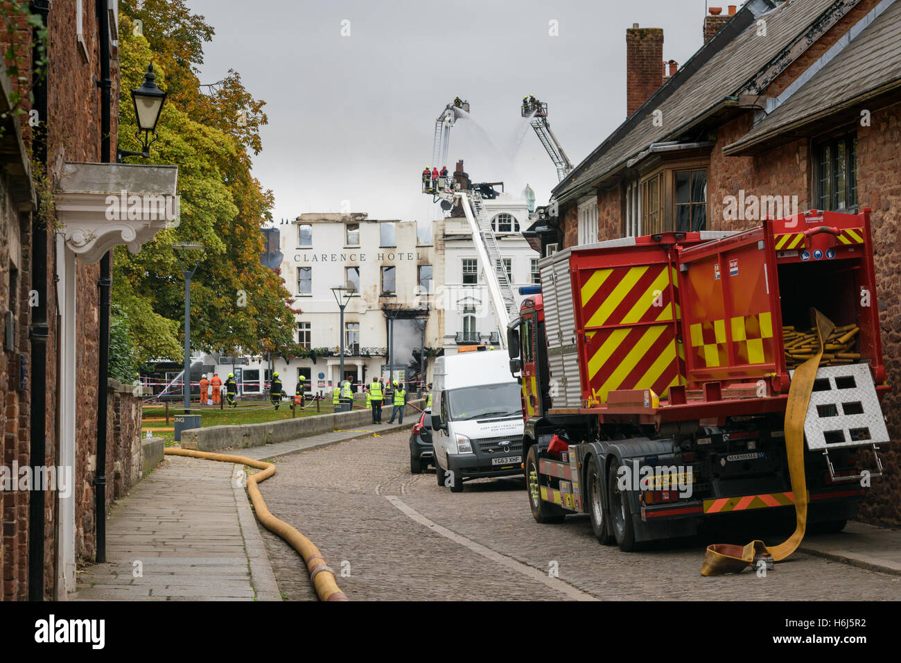 Exeter, Devon, England, UK - 29 October 2016: View of what is left of the Royal Clarence Hotel facade while the firemen keep the fire under control. The hotel is the oldest one in England. Credit: Cristina Neacsu/Alamy Live News Stock Photo