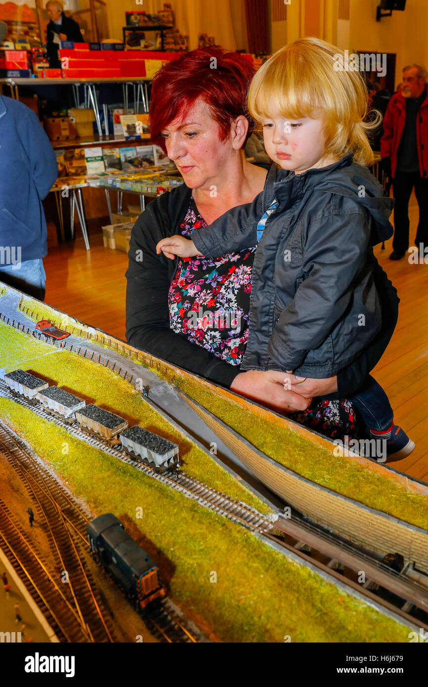 Glasgow, Scotland, UK. 29th October, 2016. On the opening day, of the two day annual Cathcart Model Railway Exhibition more than a thousand model railway enthusiasts, with ages ranging from 18 months to 100 years old, came to view the railway layouts in various guages and era.Here GABRIEL McGRATH, aged 18 months from Clydebank is with his grandmother. Credit:  Findlay/Alamy Live News Stock Photo