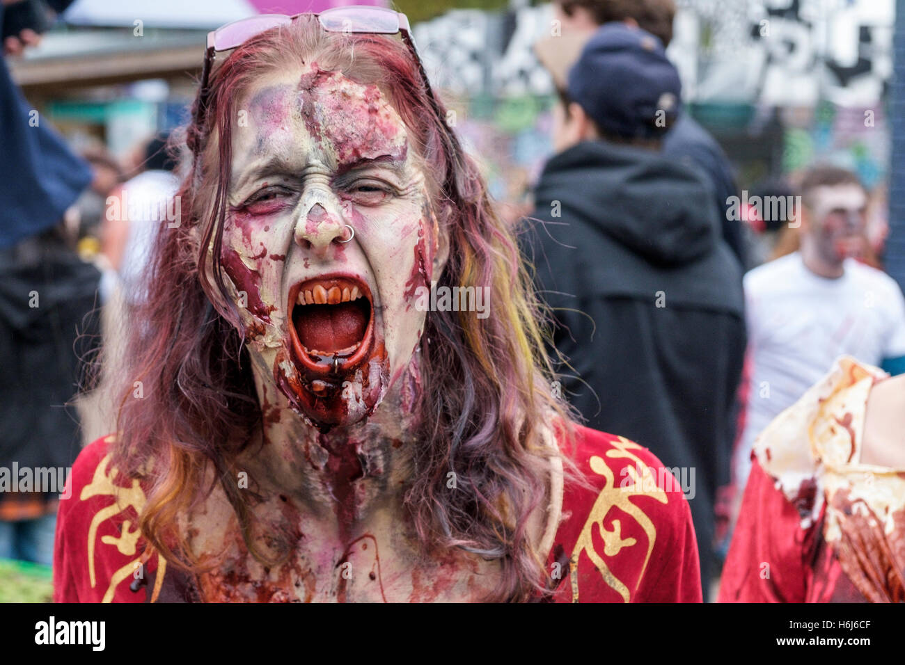 Bristol, UK. 29th Oct, 2016. A woman with a painted face,make up and dressed as a zombie is pictured as she participates in a Zombie Walk In Bristol. Credit:  lynchpics/Alamy Live News Stock Photo