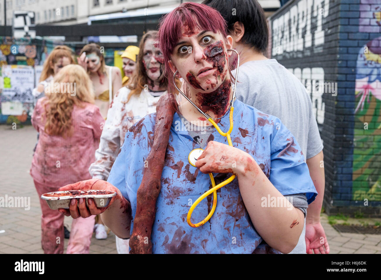 Bristol, UK. 29th Oct, 2016. A woman with a painted face,make up and dressed as a zombie is pictured as she participates in a Zombie Walk In Bristol. Credit:  lynchpics/Alamy Live News Stock Photo
