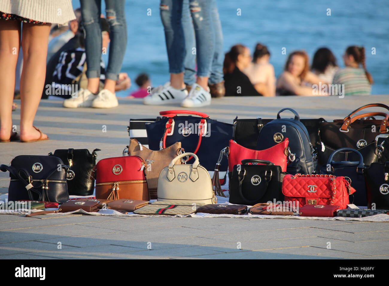 Barcelona, Spain - October 29, 2016: Copies of popular brands of bags sold on the Barceloneta beach. Although it is illegal, the phenomenon called 'top manta' is extended in central Barcelona, with hundreds of street sellers in the most popular tourist locations of the city Credit:  Dino Geromella/Alamy Live News Stock Photo