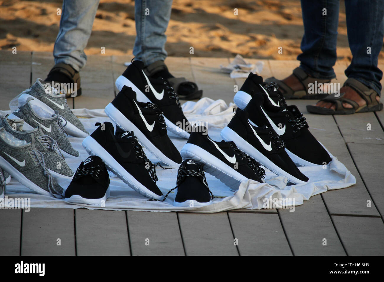 Barcelona, Spain - October 29, 2016: Copies of popular brands of shoes sold on the Barceloneta beach. Although it is illegal, the phenomenon called 'top manta' is extended in central Barcelona, with hundreds of street sellers in the most popular tourist locations of the city Credit:  Dino Geromella/Alamy Live News Stock Photo