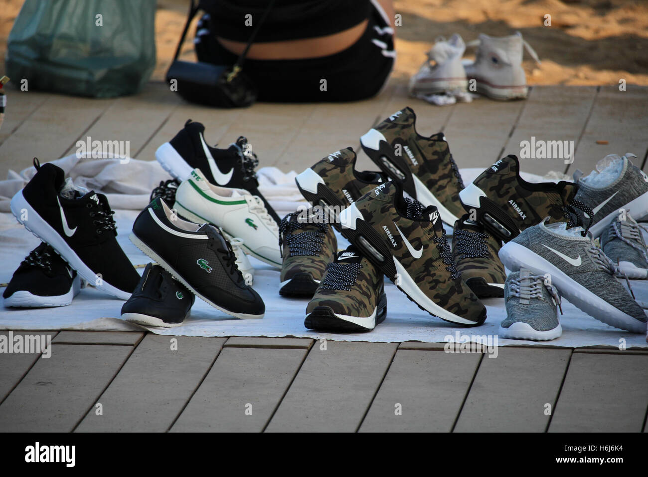 Barcelona, Spain - October 29, 2016: Copies of popular brands of shoes sold  on the Barceloneta beach. Although it is illegal, the phenomenon called  "top manta" is extended in central Barcelona, with