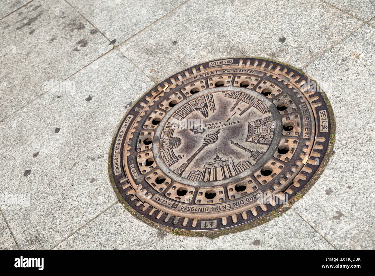 Berlin sewer cover in a street's pavement. Stock Photo