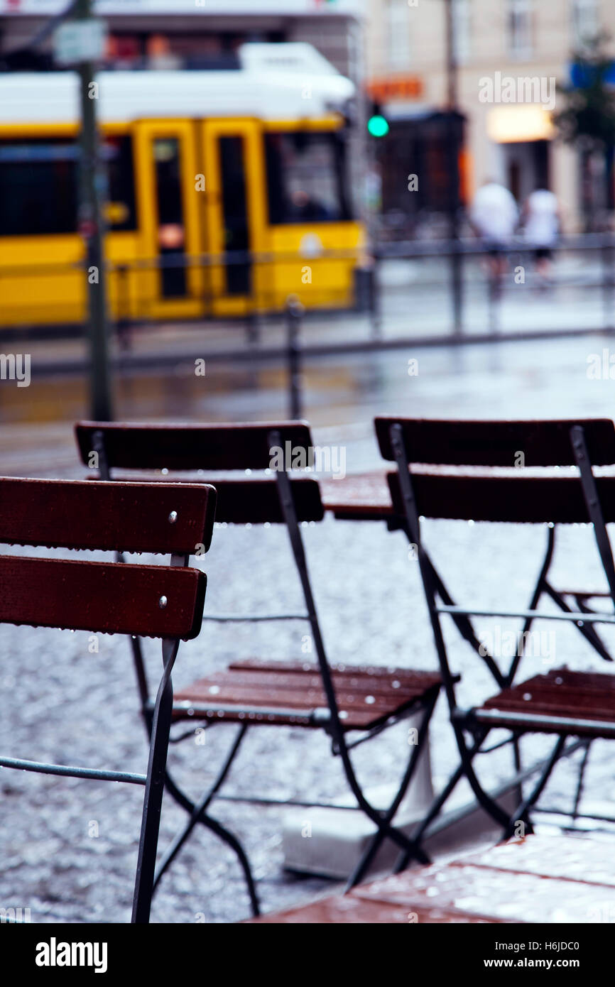 Wet Tables And Chairs Of A Cafe Wet From The Pouring Rain In Berlin Stock Photo Alamy