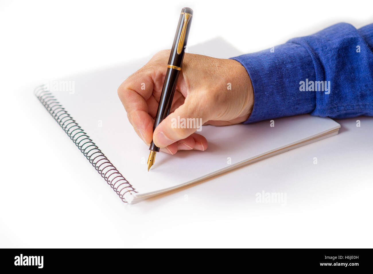 Man s hand writing with a fountain pen isolated stock photo alamy