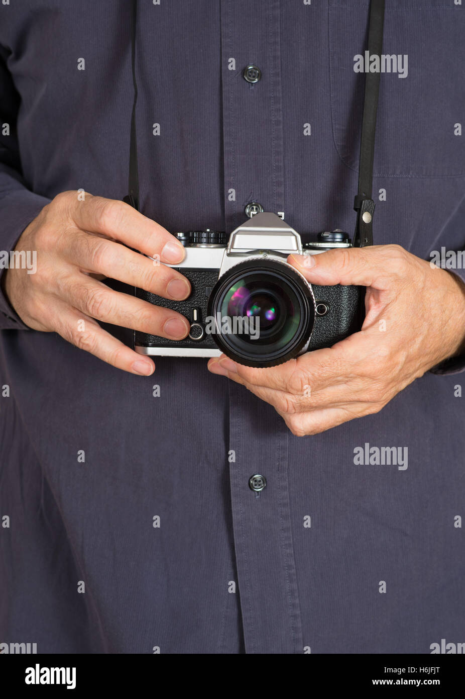 male hands holding an old analog camera SLR Stock Photo