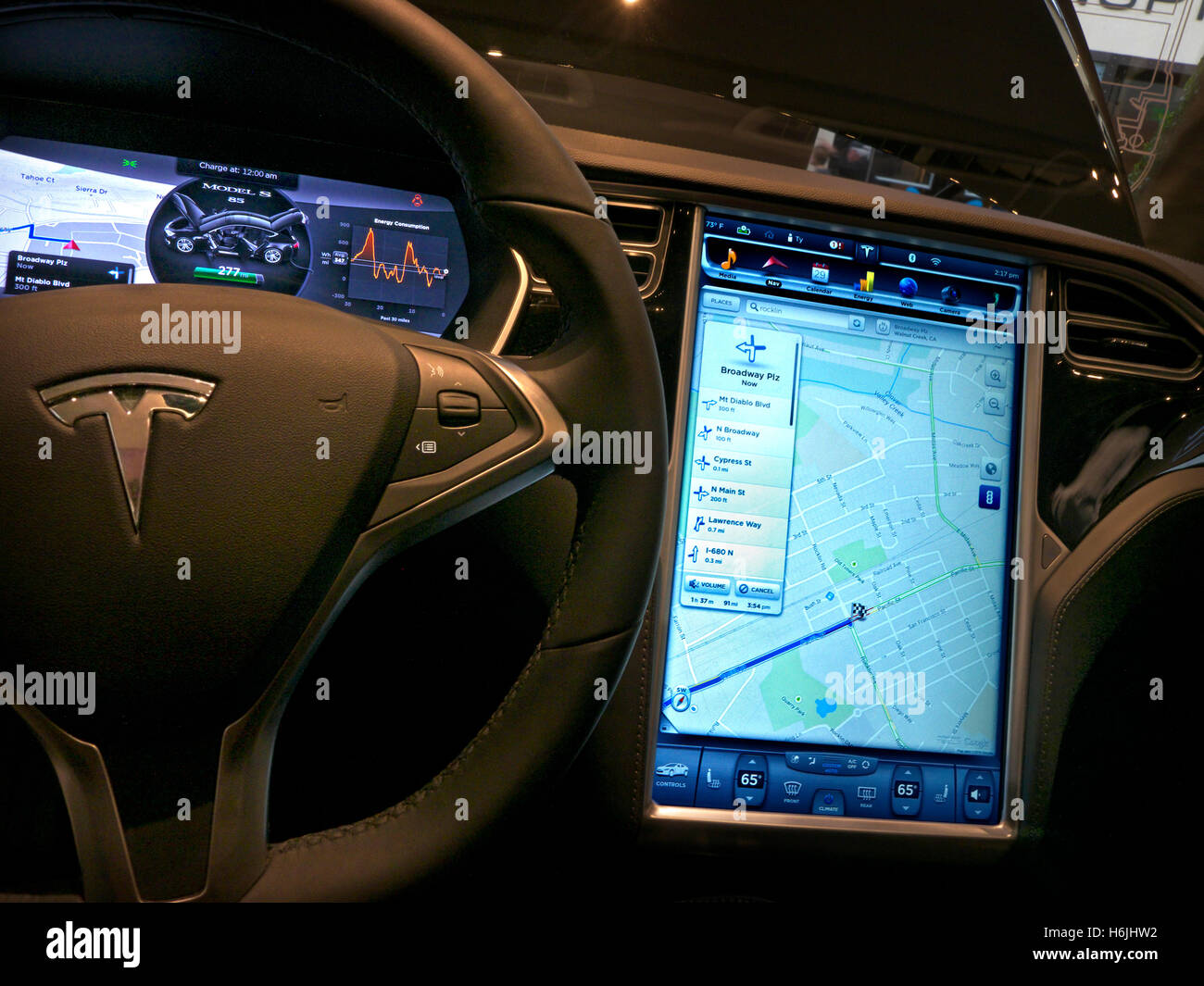 On-board navigation screen in Tesla model S showing directions Stock Photo