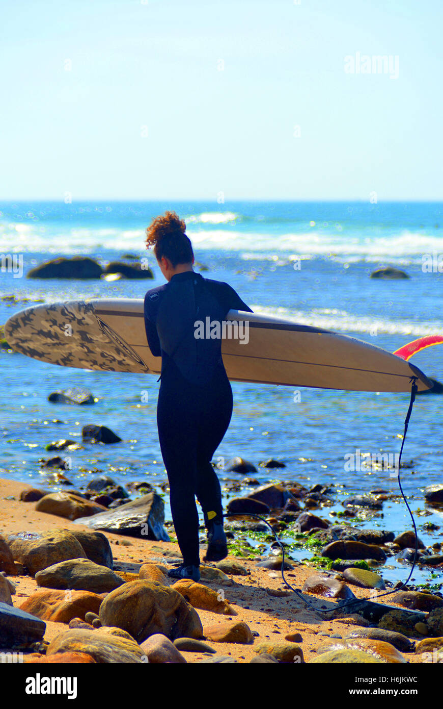 MONTAUK, NY-JUNE 13: Unidentified female surfer enters the ocean surf at Ditch Plains beach in Montauk, New York on June 13, 201 Stock Photo