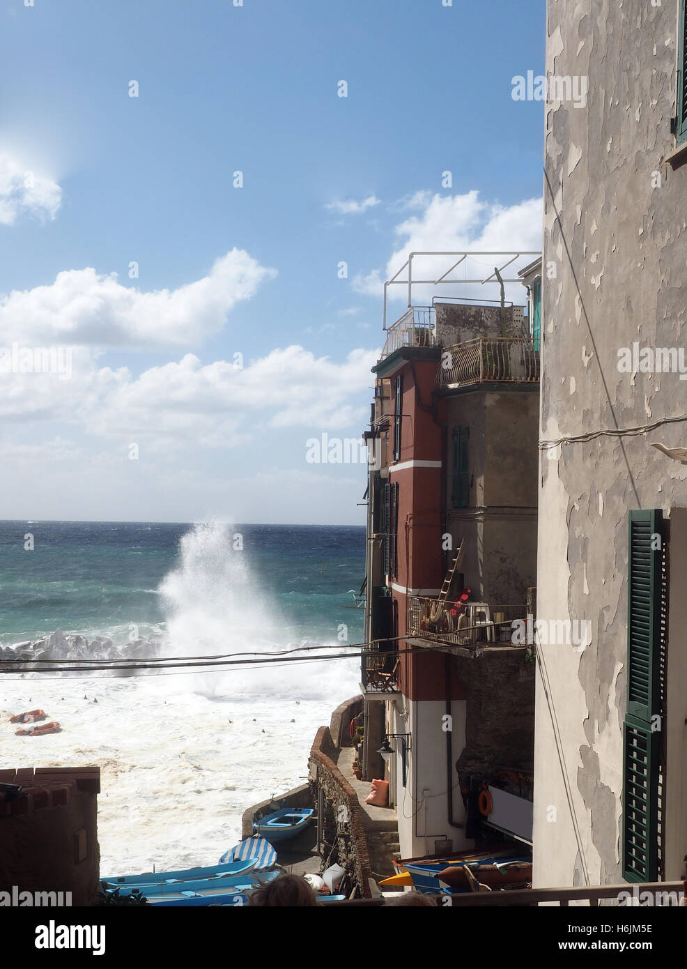 waves breaking on protective wall Riomaggiore Cinque Terre Italy Italian Riviera Stock Photo