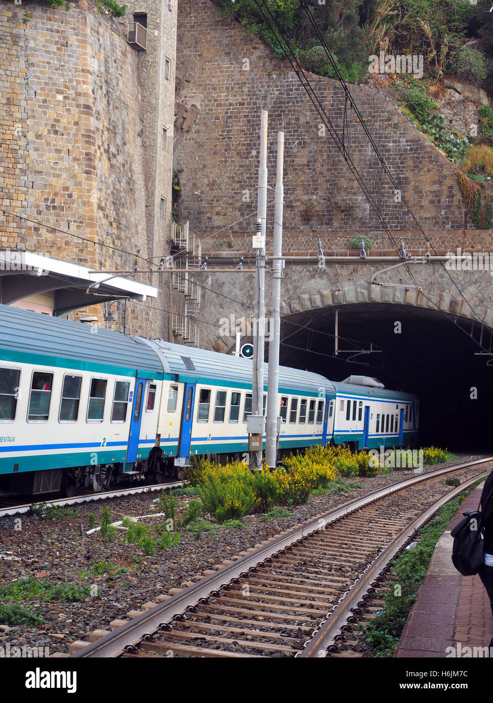 commuter train railroad in station built through mountain Cinque Terre Italy Riomaggiore Italian Riviera Stock Photo