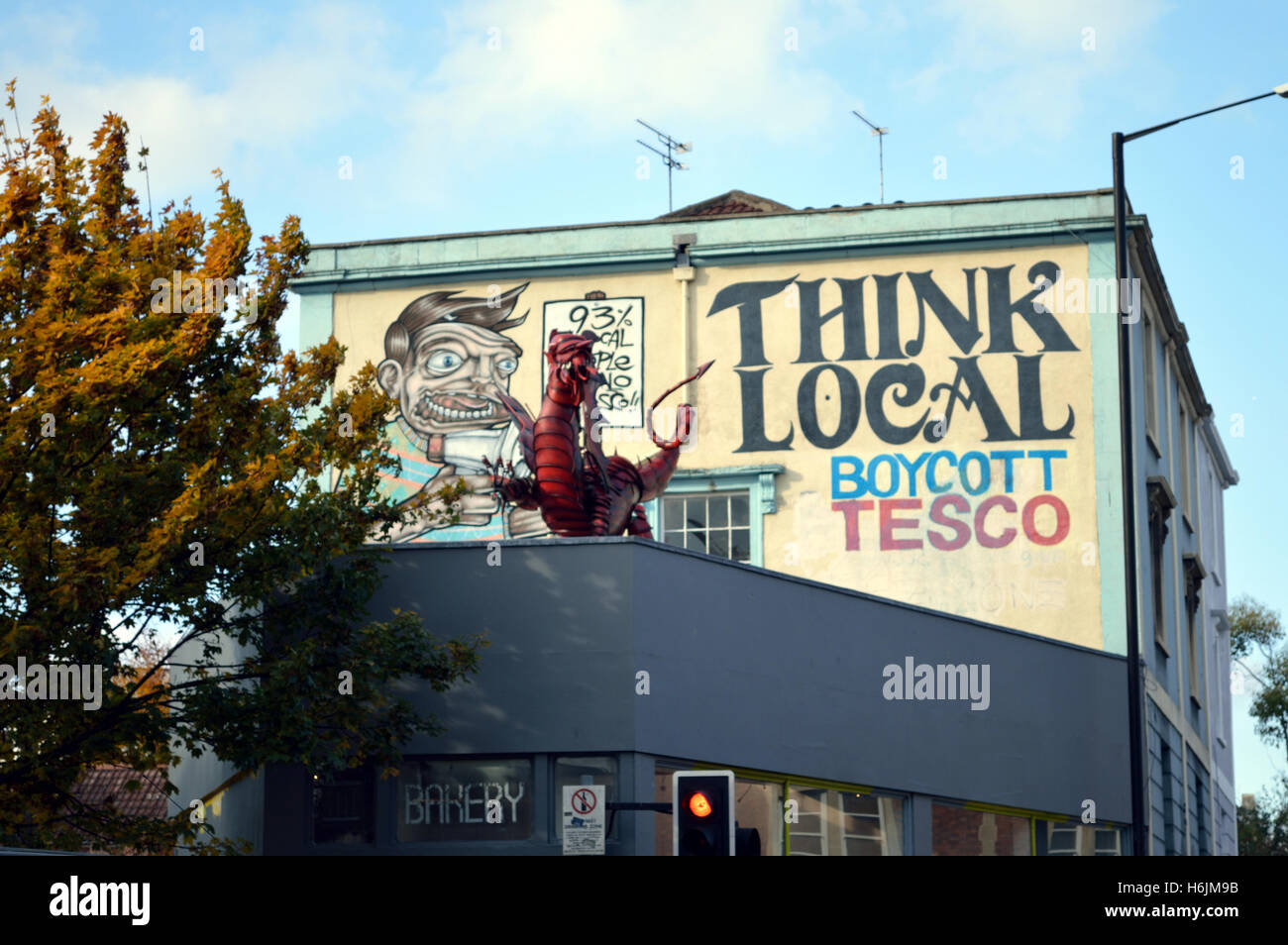 'Think local - boycott Tesco' graffiti on a wall of a house in Stokes Croft, Bristol, England, UK Stock Photo