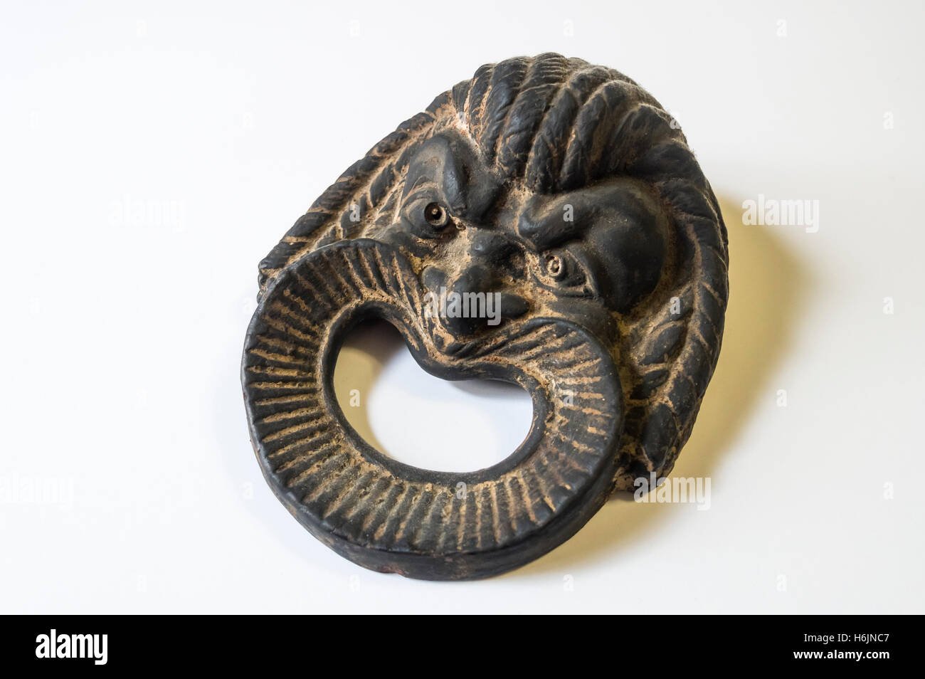 Fake Roman antiquity, a smiling theater mask Stock Photo