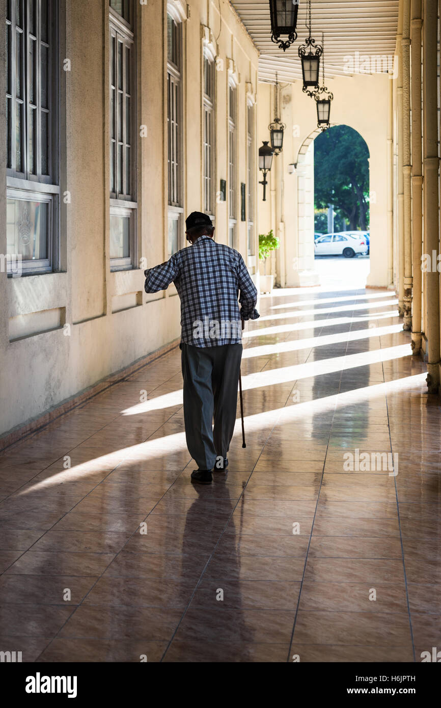 an old man with a cane on the sidewalk Stock Photo - Alamy